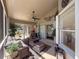 Bright sunroom featuring comfortable furniture, ceiling fan, and sliding glass doors for outdoor access at 13627 Glaze Brook Dr, Hudson, FL 34667