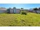 Unkept backyard featuring a grass lawn at 13730 Coco Ave, Hudson, FL 34667