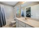 Clean bathroom featuring a shower-tub combo, updated vanity, and tiled flooring at 1418 Halapa Way, Trinity, FL 34655