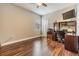 Bedroom featuring wood floors, a ceiling fan, and home office setup at 1418 Halapa Way, Trinity, FL 34655