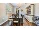 Bright dining room with hardwood floors, a chandelier, and stylish furniture at 1418 Halapa Way, Trinity, FL 34655
