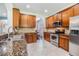 Modern kitchen features stainless steel appliances, granite countertops, and wooden cabinets at 1418 Halapa Way, Trinity, FL 34655