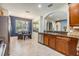 Well-lit kitchen featuring stone countertops, stainless steel appliances, and an eat-in area at 1418 Halapa Way, Trinity, FL 34655