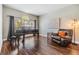 Bright living room with hardwood floors, a large window, and a comfortable leather chair at 1418 Halapa Way, Trinity, FL 34655