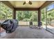 Relaxing screened patio with ceiling fan, overlooking the lush backyard at 1418 Halapa Way, Trinity, FL 34655