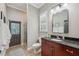 Bathroom with dark wood cabinets, shower, and a window at 15413 Azra Dr, Odessa, FL 33556
