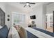 Bright bedroom with ceiling fan, window shutters, and a view of the hallway at 15413 Azra Dr, Odessa, FL 33556