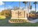 Stone community sign featuring the Grey Hawk logo with manicured landscaping at Lake Polo at 15413 Azra Dr, Odessa, FL 33556