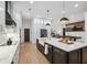 Spacious open kitchen with stainless steel appliances and a large center island with a farmhouse sink at 15413 Azra Dr, Odessa, FL 33556