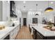Open kitchen featuring white cabinets, stainless appliances, large island and hardwood floors at 15413 Azra Dr, Odessa, FL 33556