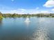 Scenic lake view with fountain and clear sky, offers community residents outdoor recreation at 15413 Azra Dr, Odessa, FL 33556
