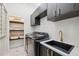 Laundry room complete with black cabinets, a sink, and shelving at 15413 Azra Dr, Odessa, FL 33556