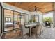 Outdoor patio with wood ceiling, dining table, and seamless access to the home at 15413 Azra Dr, Odessa, FL 33556