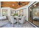 Outdoor patio with wood ceiling, dining table, and seamless access to the home at 15413 Azra Dr, Odessa, FL 33556