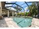 Sparkling screened-in pool features a built-in spa, brick pavers, and outdoor seating area at 15413 Azra Dr, Odessa, FL 33556