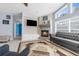 Cozy living room with fireplace and ample natural light from a big window at 18244 Autumn Lake Boulevard, Hudson, FL 34667