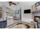 Comfortable living area featuring a fireplace and sliding door access to the pool at 18244 Autumn Lake Boulevard, Hudson, FL 34667
