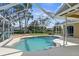 Enjoy this screened-in swimming pool, equipped with a convenient handrail for easy access and relaxation at 18244 Autumn Lake Boulevard, Hudson, FL 34667
