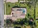 Aerial view of property with roof, pool, and lawn at 18244 Autumn Lake Boulevard, Hudson, FL 34667
