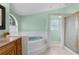 Bright bathroom with soaking tub, tiled floor, and glass shower at 18244 Autumn Lake Boulevard, Hudson, FL 34667