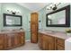 Bathroom with dual vanities, generous storage, and neutral decor at 18244 Autumn Lake Boulevard, Hudson, FL 34667