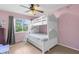 Colorful bedroom features a bunk bed, large window, and durable flooring at 18244 Autumn Lake Boulevard, Hudson, FL 34667