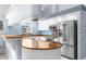 Modern kitchen with stainless steel appliances, ample counter space, and breakfast bar seating at 18244 Autumn Lake Boulevard, Hudson, FL 34667