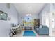 Bright and airy room featuring a desk area, tile floors, and natural light through the windows at 18244 Autumn Lake Boulevard, Hudson, FL 34667