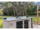 Outdoor kitchen with sink, countertops, and storage, surrounded by nature at 18244 Autumn Lake Boulevard, Hudson, FL 34667