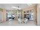 Spacious enclosed patio with skylights, multiple sliding doors, and elegant wicker furniture at 18244 Autumn Lake Boulevard, Hudson, FL 34667