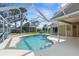 Backyard features a refreshing screened-in pool with a covered patio, ideal for outdoor enjoyment at 18244 Autumn Lake Boulevard, Hudson, FL 34667