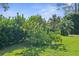 Landscaped yard with mature trees and fruit trees at 18244 Autumn Lake Boulevard, Hudson, FL 34667