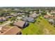 An aerial showcases homes in a verdant community with pools and mature landscaping at 18520 Hidden Pines Way, Hudson, FL 34667
