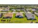 Aerial view of homes in a residential neighborhood with green lawns and trees at 18520 Hidden Pines Way, Hudson, FL 34667