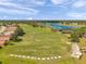 Scenic aerial view featuring a golf course, lake, and residential neighborhood at 18520 Hidden Pines Way, Hudson, FL 34667