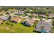 Aerial view showcasing a well-maintained neighborhood with lush green lawns and mature trees at 18520 Hidden Pines Way, Hudson, FL 34667