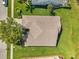 The roof is the focus of this image of an aerial view of the property at 18520 Hidden Pines Way, Hudson, FL 34667