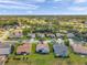 Bird's eye view showing a neighborhood with lush green lawns, mature trees and houses with pools at 18520 Hidden Pines Way, Hudson, FL 34667