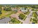 Expansive aerial view of homes and community featuring lush landscaping, golf course, and a pond at 18520 Hidden Pines Way, Hudson, FL 34667