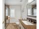Bright bathroom with granite countertop vanity, large mirror, window, and tiled walk-in shower at 18520 Hidden Pines Way, Hudson, FL 34667