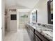 A spacious bathroom with double vanity, granite counters, and a tiled shower creating a luxurious experience at 18520 Hidden Pines Way, Hudson, FL 34667