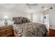 A cozy bedroom with a patterned duvet, decorative pillows, and wood furniture creating a relaxing atmosphere at 18520 Hidden Pines Way, Hudson, FL 34667