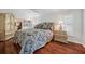 Bedroom featuring hard wood floors, a decorative ceiling fan and a wardrobe at 18520 Hidden Pines Way, Hudson, FL 34667