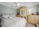 A peaceful bedroom with neutral colors, decorative pillows, and carved wood furniture adding to the relaxing ambiance at 18520 Hidden Pines Way, Hudson, FL 34667