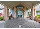 Inviting entryway features brick pillars, a covered entrance, and a welcoming seating area at 18520 Hidden Pines Way, Hudson, FL 34667