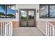Commercial building entrance with brick accents, double doors, and symmetrical windows on either side at 18520 Hidden Pines Way, Hudson, FL 34667