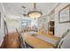 Bright dining room with hardwood floors and a view to the living room and kitchen at 18520 Hidden Pines Way, Hudson, FL 34667