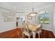 Elegant dining room featuring hardwood floors and stylish chandelier at 18520 Hidden Pines Way, Hudson, FL 34667