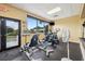 Bright exercise room equipped with stationary bikes, windows, and a mounted tv at 18520 Hidden Pines Way, Hudson, FL 34667