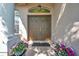 Inviting double front doors with decorative glass and colorful flower planters at 18520 Hidden Pines Way, Hudson, FL 34667